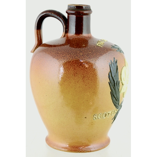 620 - J.R.D. SCOTCH WHISKY JUG. (WG p 157) 7ins tall. Variating tan salt glaze, rear handle, applied front... 