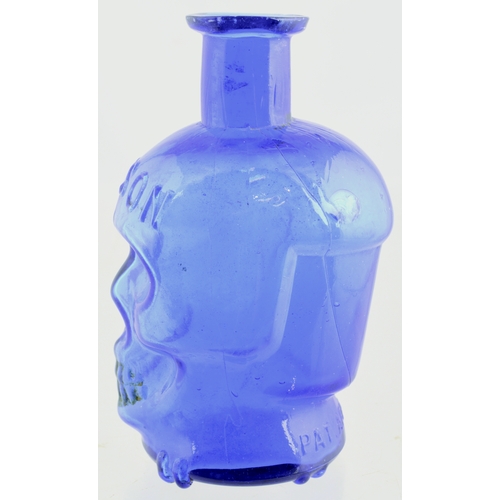 654 - SKULL POISON BOTTLE. (DP p 20) 4.25ins tall. Vivid cobalt blue glass formed as skull, crossed bones ... 