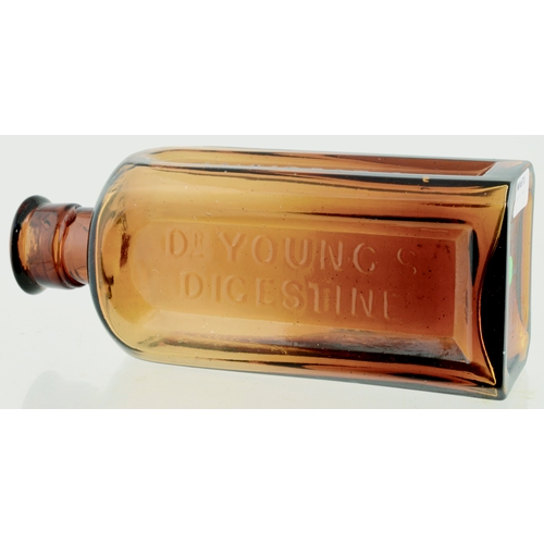 663 - DR YOUNGS DIGESTINE CURE BOTTLE. 5.5ins tall. Amber glass, applied lip, rectangular shape, 3 facette... 