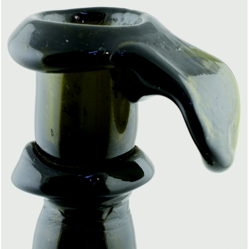 696 - ENGLISH HOGSCRAPER BOTTLE/ CANDLESTICK. 6.75ins tall. Dark green, almost black glass bottle formed a... 