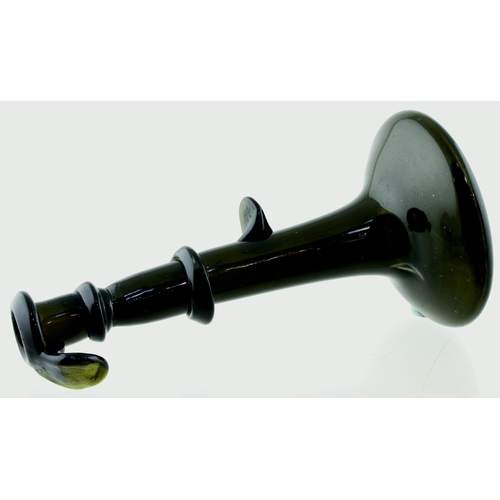 696 - ENGLISH HOGSCRAPER BOTTLE/ CANDLESTICK. 6.75ins tall. Dark green, almost black glass bottle formed a... 