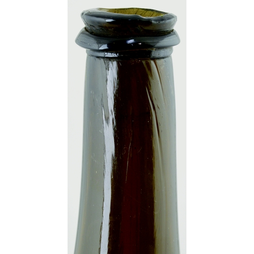 704 - FAT BODIED CYLINDER WINE BOTTLE. 9.75ins tall. Variating amber/ brown, slighlty dimpled glass, long ... 