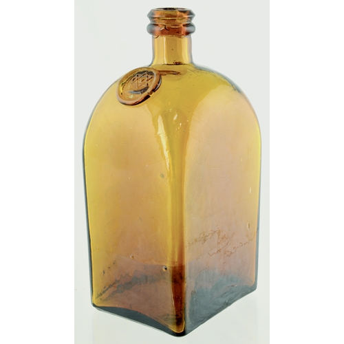 709 - BITTERS BOTTLE. 7ins tall. Slightly flattened rectangular shape, rounded shoulders, amber glass with... 