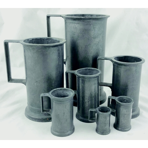 241 - PEWTER TANKARDS SET. Tallest 7.5ins, handled seven piece graduated pewter tankards. (7)