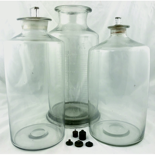 242 - CHEMIST JAR GROUP. Tallest 14.5ins, clear glass, one with measurements plus tiny weights. (4)