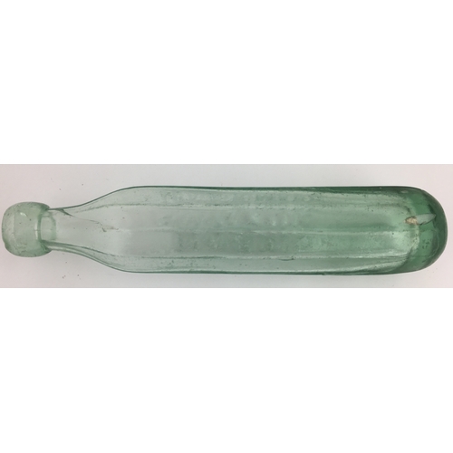 122 - SWINTON FACETTED MAUGHAMS PATENT BOTTLE. 10ins long, very crudely made aqua glass (dark at base)roun... 