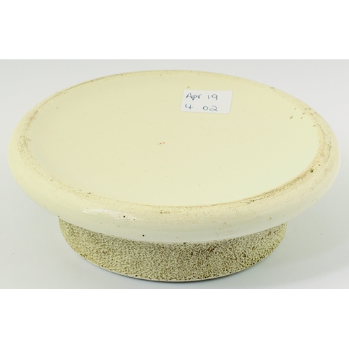 14 - SALT & COS BURTON MATCHSTRIKER. 5.25ins diam. Circular shape off white glaze, textured central strik... 