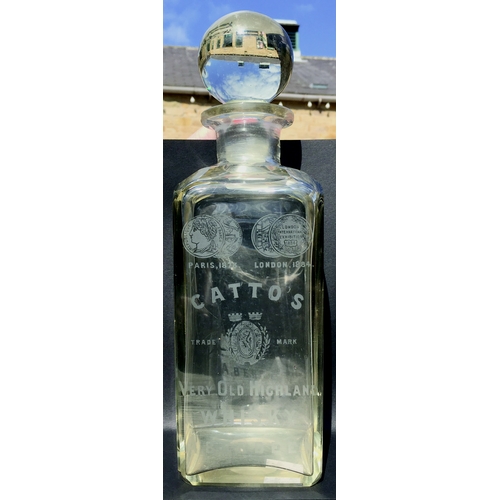 30 - CATTO’S WHISKY DECANTER. 11ins tall to top of spherical stopper. Clear glass rectangular form decant... 