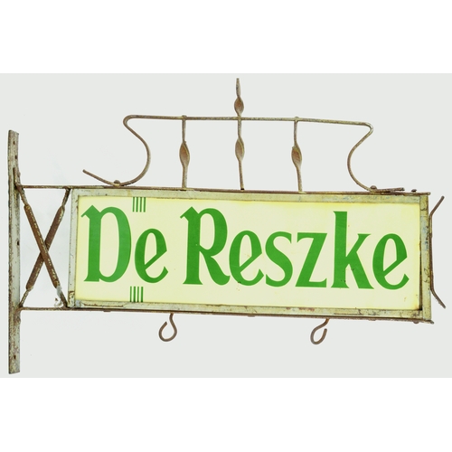 70 - DE RESZKE HANGING ENAMEL SHOP SIGN. 22ins across. Double sided enamel sign within wrought iron surro... 