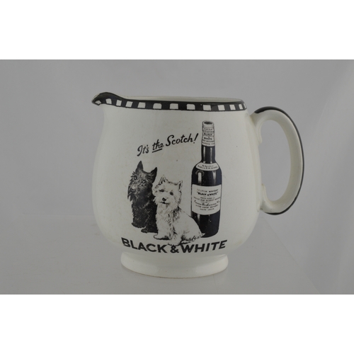 135 - BLACK & WHITE WHISKY WATER JUG. 5ins tall. Bulbous body jug with the classic Scottie dogs & bottle o... 