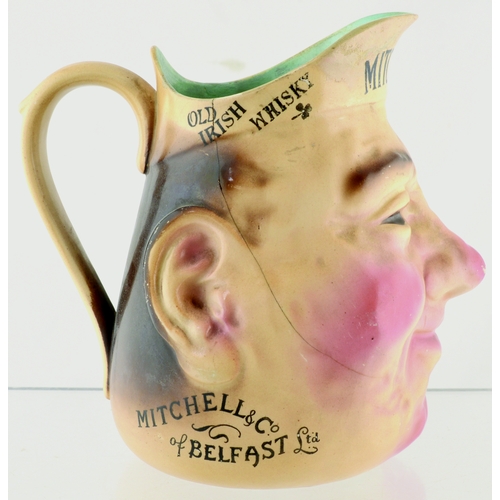 158 - BELFAST MITCHELLS OLD IRISH WHISKY HEAD JUG. 6.25ins tall. Character Jug in form of smiling head, ad... 