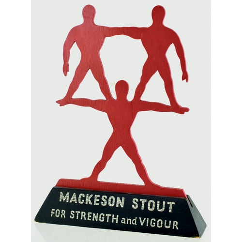 179 - MACKESON STOUT ADVERTISING PIECE. 10ins tall. Wooden construction of 3 male figures, two stood on on... 