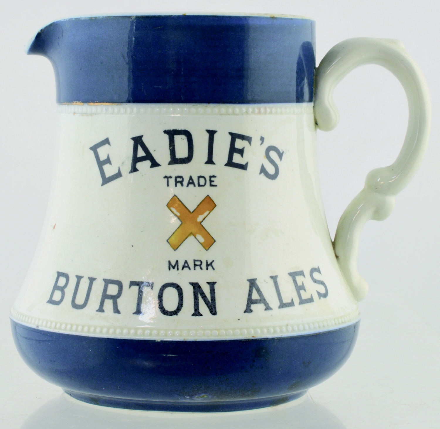 EADIE S BURTON ALES BEER JUG. 5.25ins tall. White glaze with dark