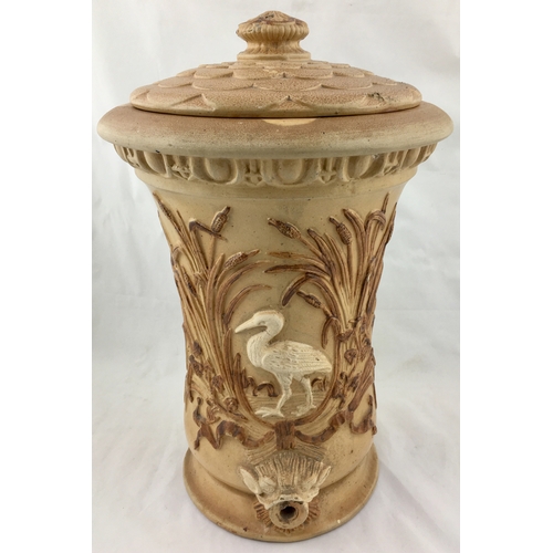 62A - STONEWARE WATER FILTER. 15ins tall. All over light tan salt glaze, with raised detail of heron (?) w... 