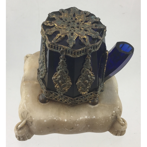 88 - TEAKETTLE INK. 3.5ins tall. Dark cobalt
blue glass eight sided, encased with ornate metal casing wit... 