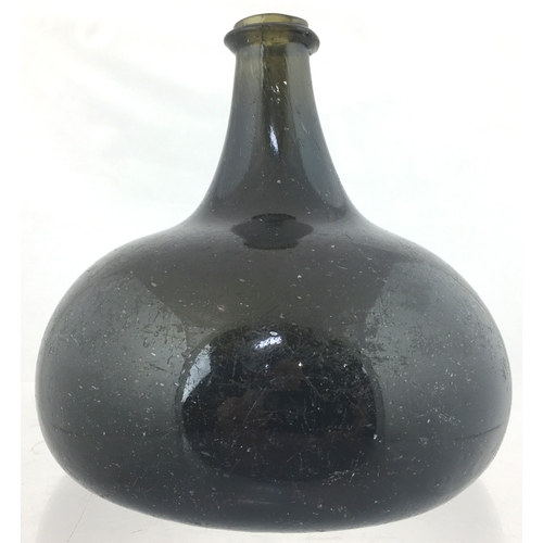 114 - PANCAKE ONION WINE BOTTLE. 6ins
tall. Very dark, almost black glass (shows some
blue in certain ligh... 