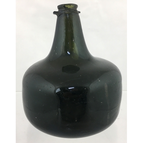 115 - MALLET WINE BOTTLE. 6ins tall. Very
dark, almost black glass true mallet form. Squat
short neck, app... 