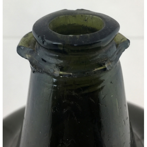 115 - MALLET WINE BOTTLE. 6ins tall. Very
dark, almost black glass true mallet form. Squat
short neck, app... 