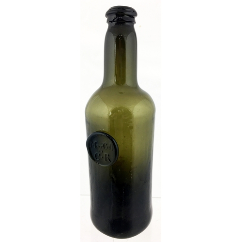 116 - SEALED CYLINDER WINE BOTTLE. 11ins tall.
Variating green glass, rounded shoulders, applied seal MAG ... 