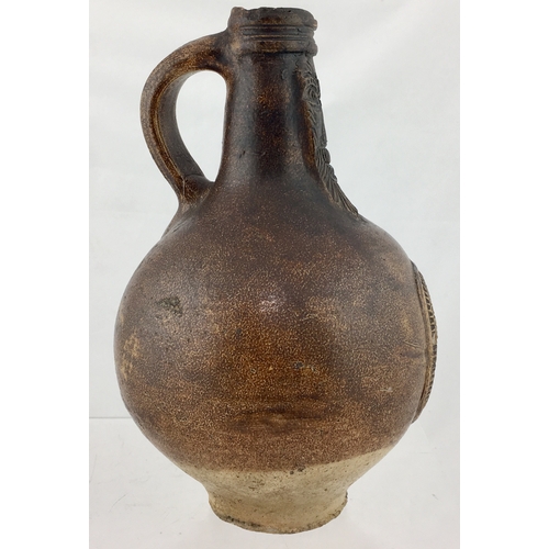 121 - BELLARMINE JUG. 8.25ins. Dipped brown body
glaze with some runs. Bulbous bodied, bearded face cartou... 