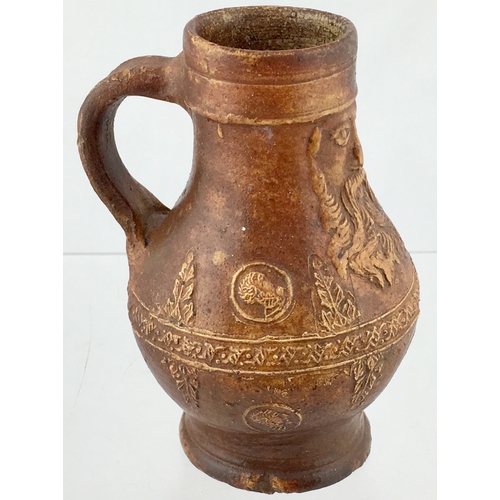 123 - BELLARMINE JUG. 5.75ins tall. All over tan glaze, bulbous bodied bellarmine jug, bearded face below ... 