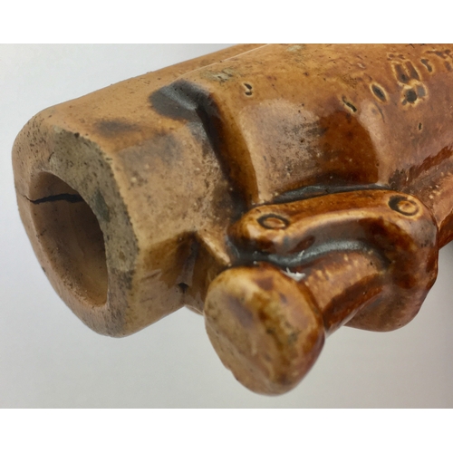 139 - PISTOL FLASK. 12ins long. Tan salt glaze
flask formed as a flintlock pistol with
various scraffitto ... 