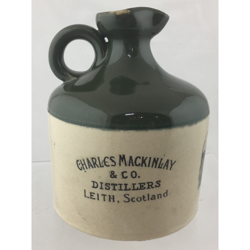 156 - MACKINLAY’S WHISKY JUG. (WG
p 119) 6.25ins tall. Green top, lower off white
glaze, raised horseshoe ... 