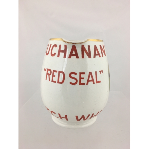 161 - BUCHANAN’S RED SEAL WHISKY
WATER JUG. 5.5ins tall. Bulbous body,
white glaze with BUCHANAN’S/ RED
SE... 