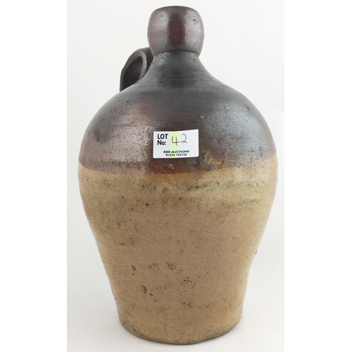 42 - SALTGLAZED FLAGON. 10.5ins, t, t, handle to rear with top & bottom hairline plus chip.