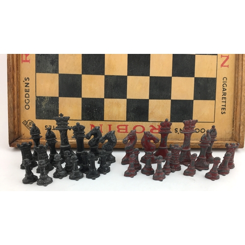 276 - OGDEN’S ROBIN CIGARETTES CHESS SET. 13ins diam, wooden board with metal pieces.