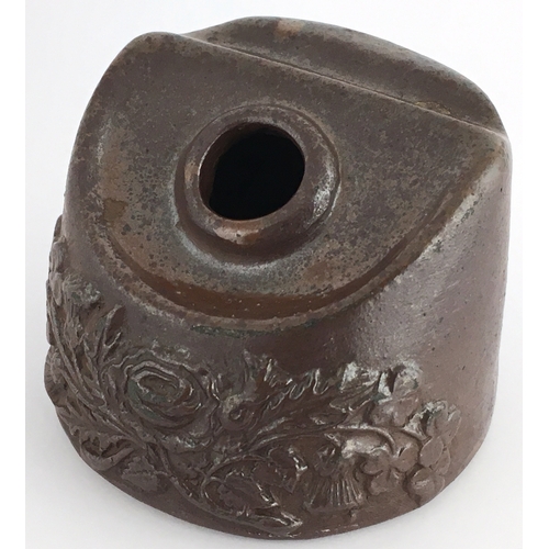 545 - SALT GLAZE INKWELL. 2ins at tallest part. Dark brown glaze, moulded floral sprigging below central f... 