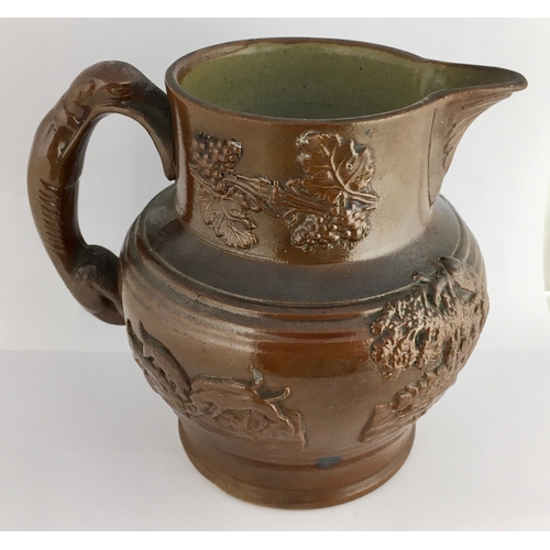 567 - BRAMPTON JUG. 6.5ins tall. All over dark brown glaze, rear greyhound handle. Raised sprig detail ‘Th... 