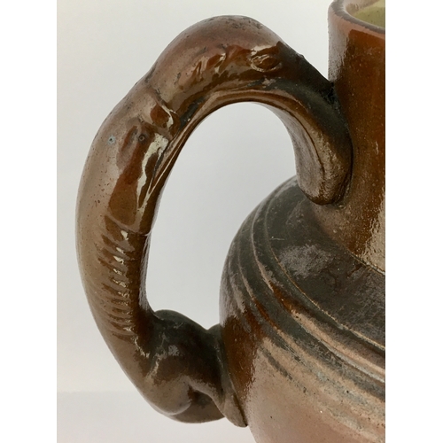 567 - BRAMPTON JUG. 6.5ins tall. All over dark brown glaze, rear greyhound handle. Raised sprig detail ‘Th... 