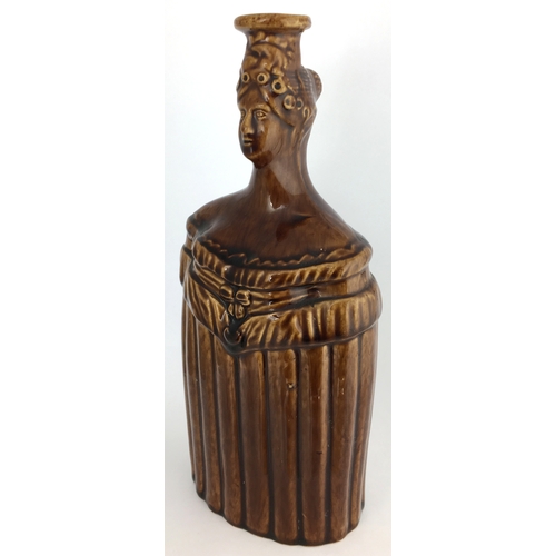 580 - QUEEN VICTORIA SPIRIT FLASK. (Reform Flask pg 51) 9ins tall. Shiny brown Rockingham type glaze flask... 