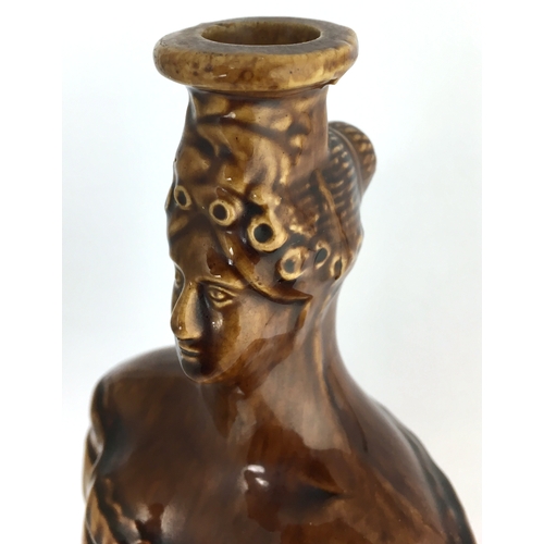 580 - QUEEN VICTORIA SPIRIT FLASK. (Reform Flask pg 51) 9ins tall. Shiny brown Rockingham type glaze flask... 