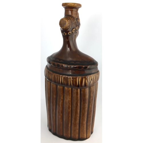 580 - QUEEN VICTORIA SPIRIT FLASK. (Reform Flask pg 51) 9ins tall. Shiny brown Rockingham type glaze flask... 