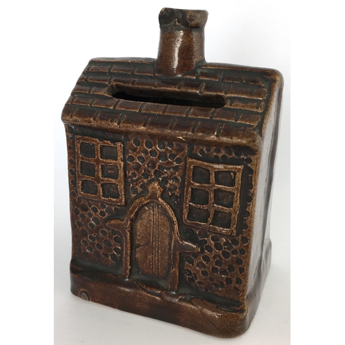 581 - EARLY ROCKINGHAM GLAZE MONEY BOX. 3.5ins tall. Small shiny brown glazed money box formed as house wi... 