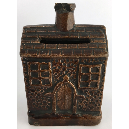 581 - EARLY ROCKINGHAM GLAZE MONEY BOX. 3.5ins tall. Small shiny brown glazed money box formed as house wi... 