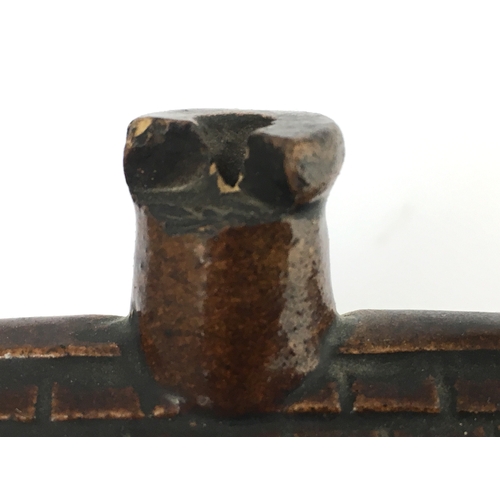 581 - EARLY ROCKINGHAM GLAZE MONEY BOX. 3.5ins tall. Small shiny brown glazed money box formed as house wi... 