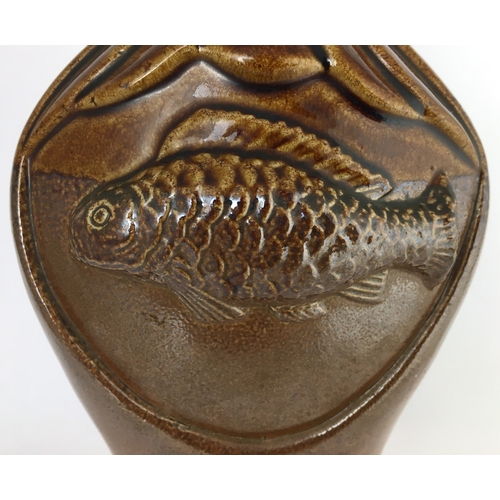 582 - MOULDED FISH SPRIGGED FLASK. 8.25ins tall. Very shiny brown top section, lower dark brown salt glaze... 