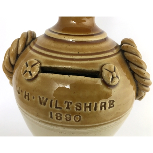 586 - WEST COUNTRY DATED 1890 STONEWARE MONEY BOX. 7ins tall., t..t tan, barley twist handle detail either... 