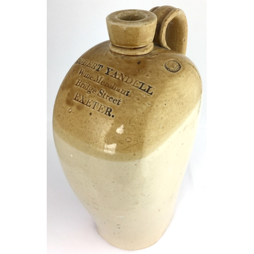 595 - EXETER SPIRIT FLASK. 11ins tall. T.t. tan/ flat sided flagon, rounded shoulders, rear handle. Front ... 