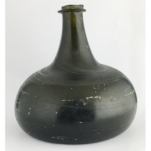 597 - ENGLISH ONION WINE BOTTLE. 5.1ins tall, deep dark black/ green glass, c. 1700-1710, thin string lip ... 