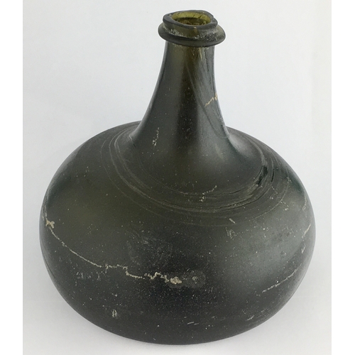 597 - ENGLISH ONION WINE BOTTLE. 5.1ins tall, deep dark black/ green glass, c. 1700-1710, thin string lip ... 