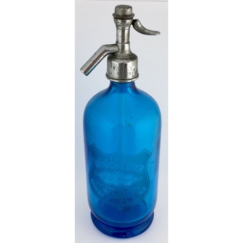 641 - WINCHESTER SODA SYPHON. 11.75ins tall to top of impressed trigger. Blue glass, footed base, etched t... 