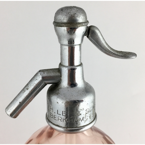 642 - BERKHAMSTED SODA SYPHON. 12ins tall to top of impressed trigger. Salmon pink coloured glass, vertica... 