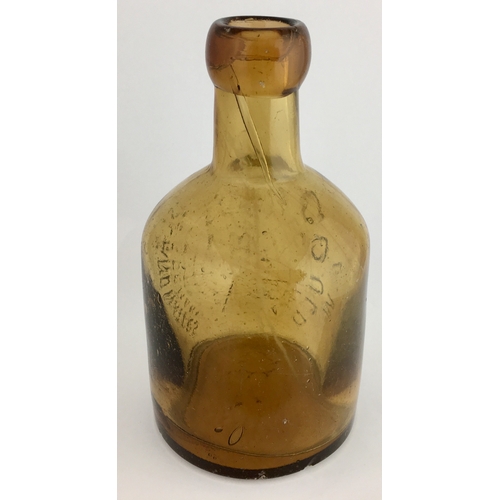 646 - ISLE OF WIGHT SELTZER BOTTLE. 6ins tall. Amber glass, embossed vertically around circular donkey in ... 