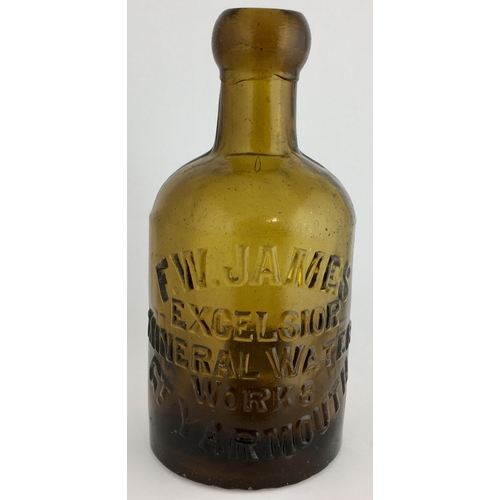 647 - GT YARMOUTH SELTZER BOTTLE. 6.25ins tall. Dark amber glass, heavily embossed F.W. JAMES / EXCELSIOR/... 