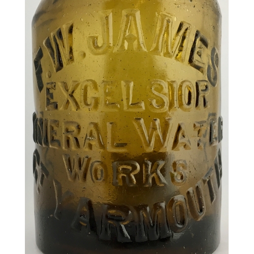 647 - GT YARMOUTH SELTZER BOTTLE. 6.25ins tall. Dark amber glass, heavily embossed F.W. JAMES / EXCELSIOR/... 