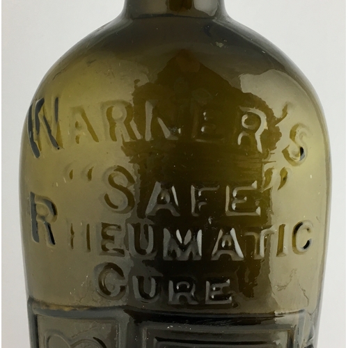 658 - WARNERS SAFE RHEUMATIC CURE BOTTLE. 9.5ins tall. One pint, olive amber glass, sloping shoulders, sho... 